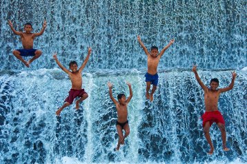 indonesia boys waterfall water leap joy